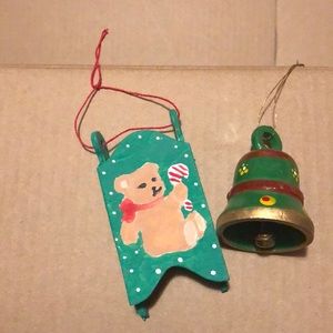 Two vintage ornaments. Wooden painted sled with teddy bear and a wooden bell.